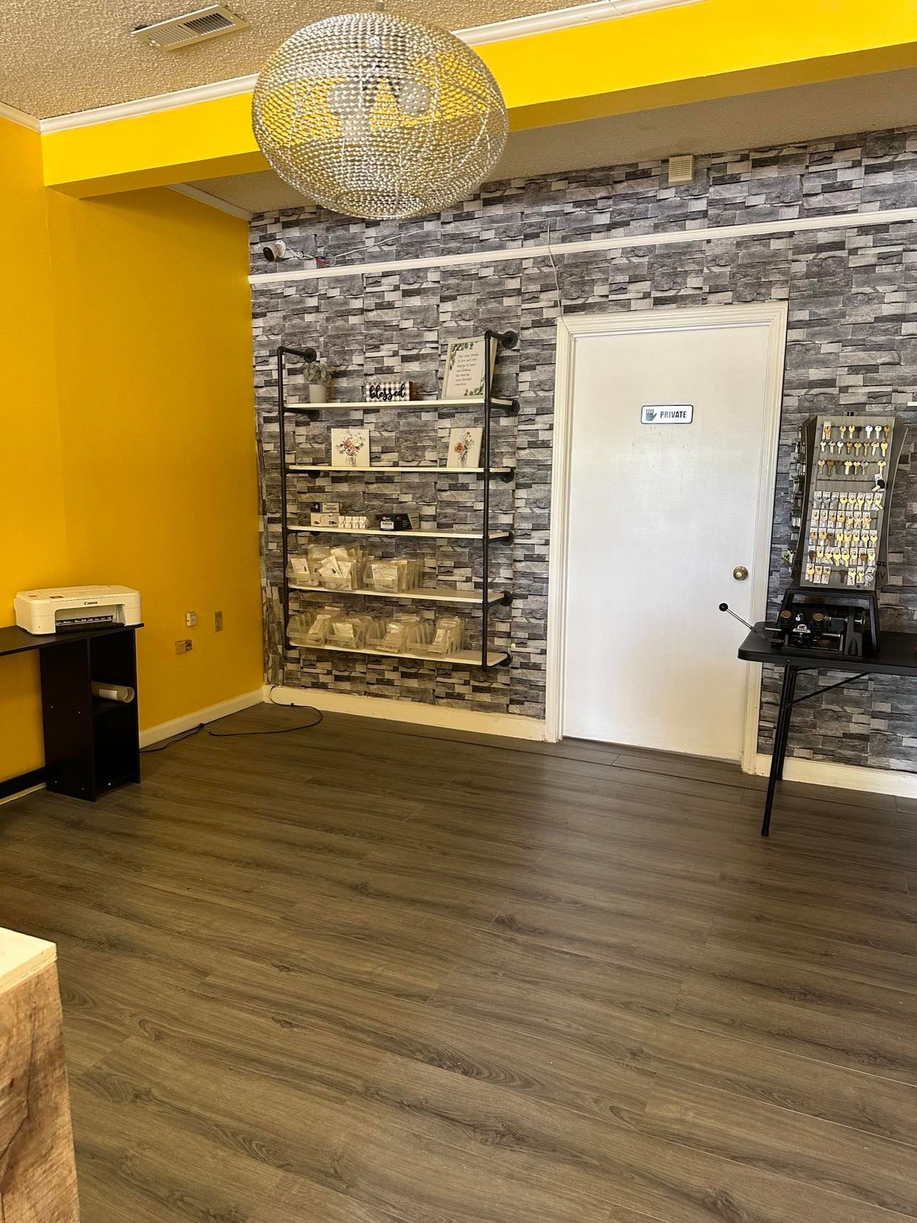 A room with a wooden floor and a brick wall.