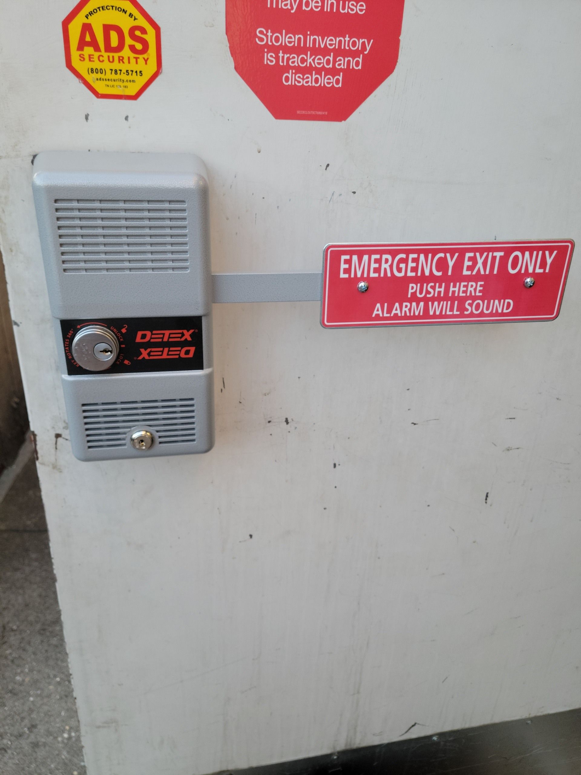 A white safe with an emergency exit only sign on it