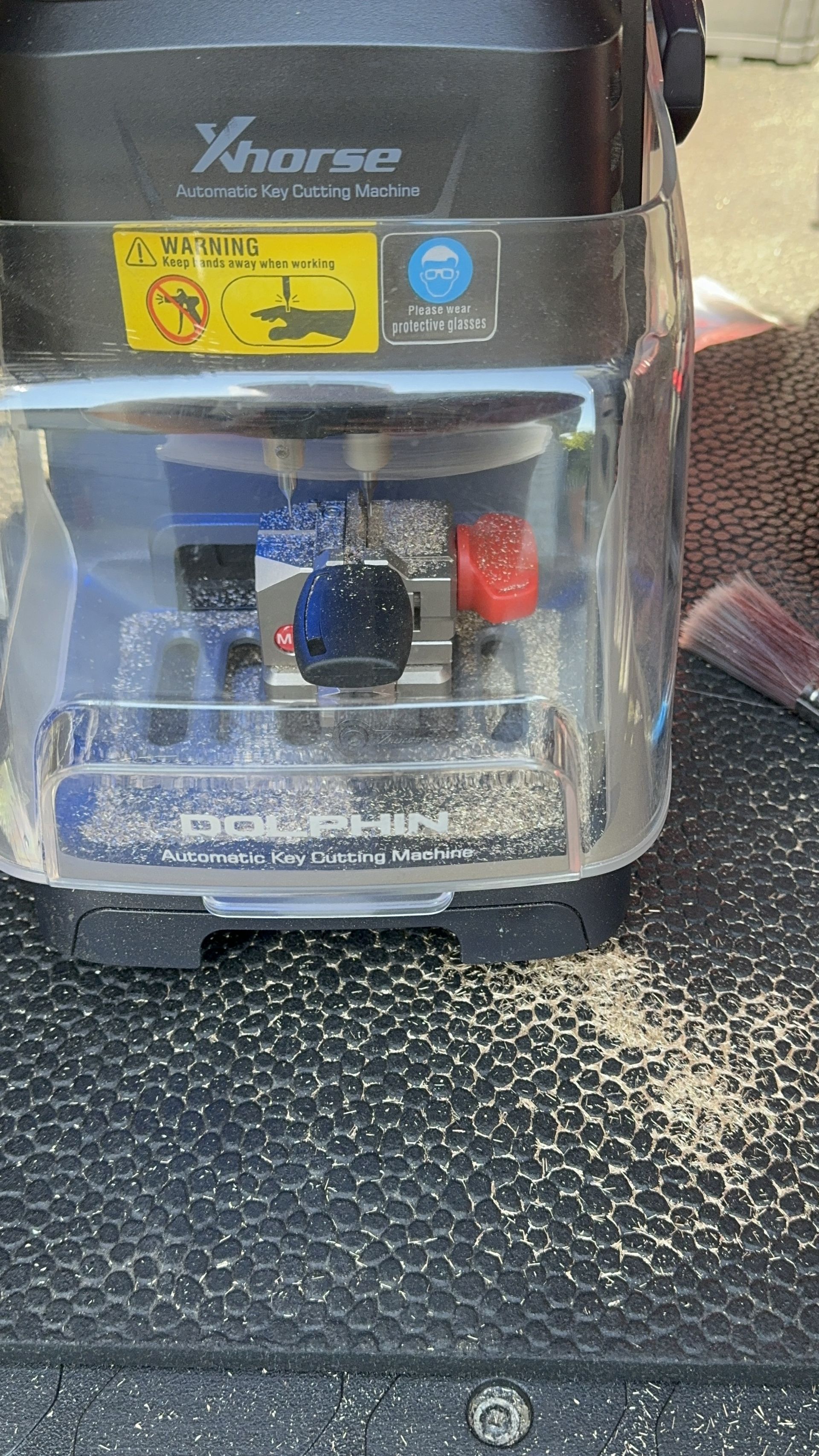 A close up of a key cutting machine on a table.