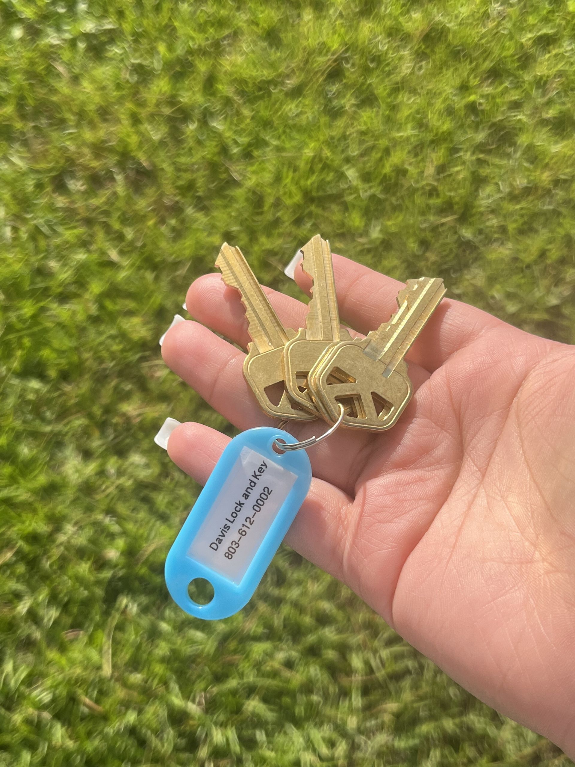 A person is holding a bunch of keys in their hand.