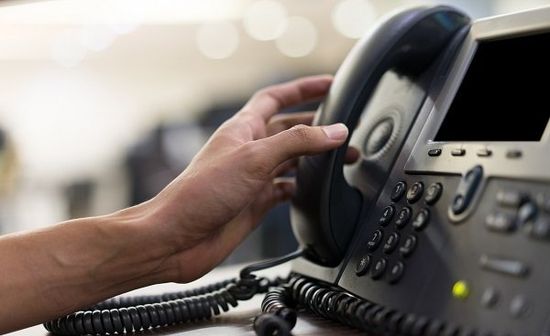 Man Hand Touching Handset Of Telephone — Norfolk, VA — Secretariats Inc.