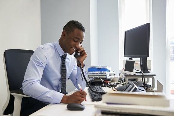 Man Talking on the Phone While Writing — Norfolk, VA — Secretariats Inc.