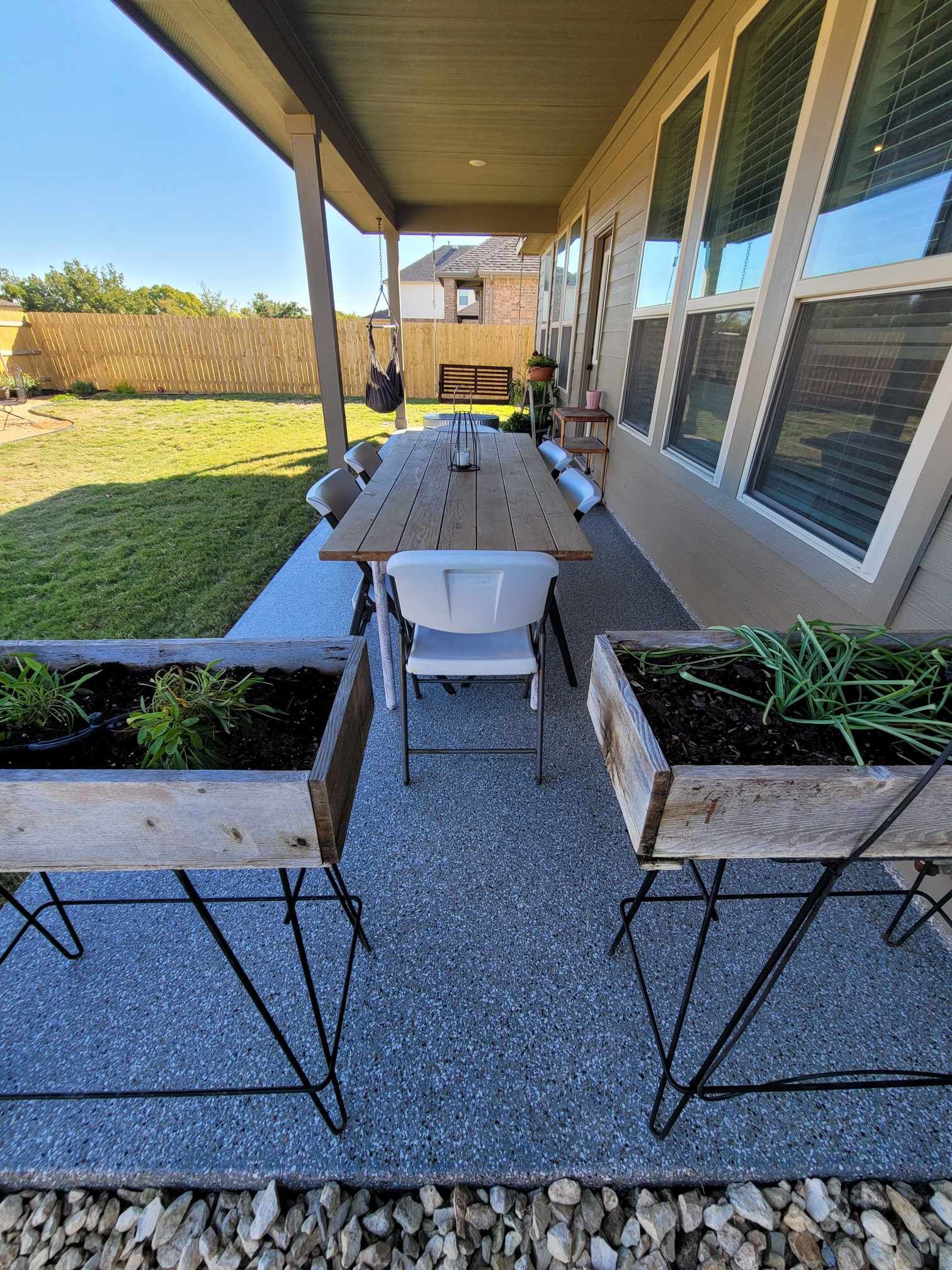 there is a table and chairs on the porch of a house.