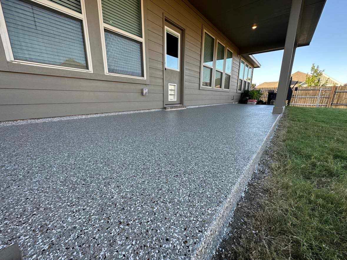 a house with a porch and a concrete floor.