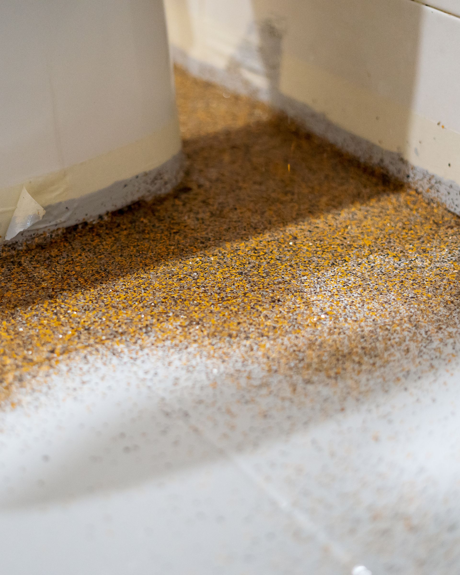 a close up of a bathroom floor with a white sink .