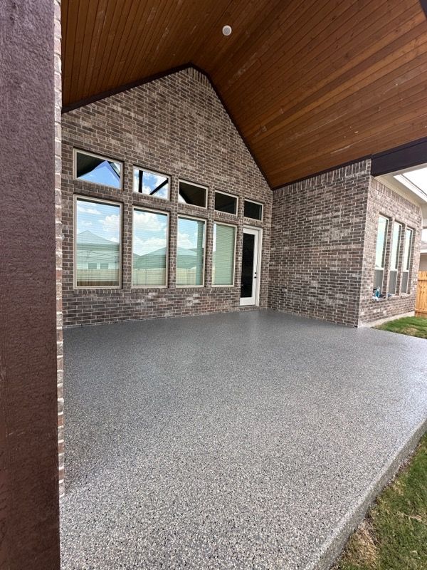 a large brick house with a covered patio in front of it