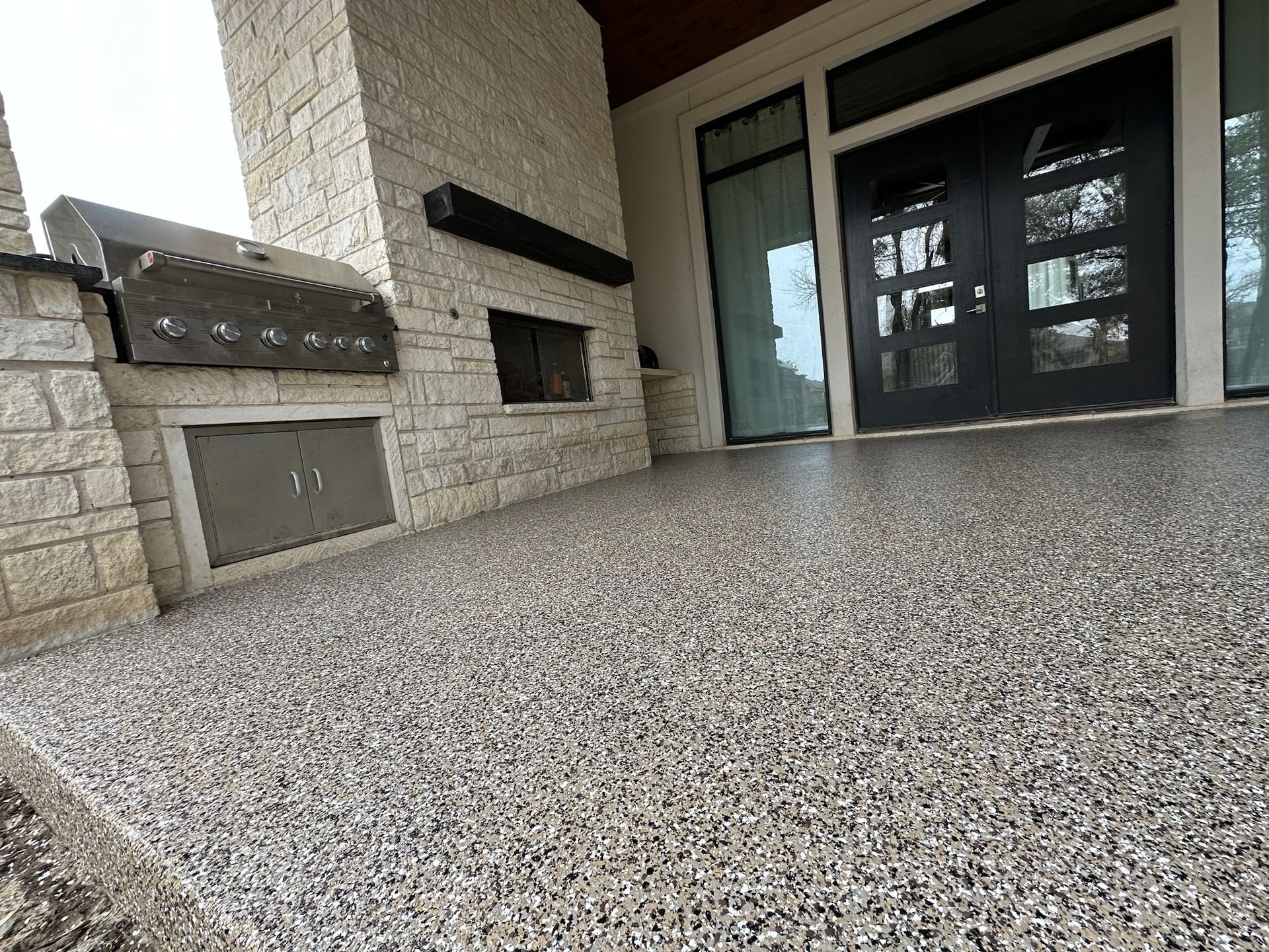 a patio with a fireplace and a concrete floor .