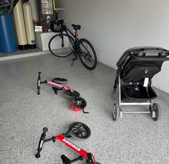 a bicycle and a stroller are in a garage