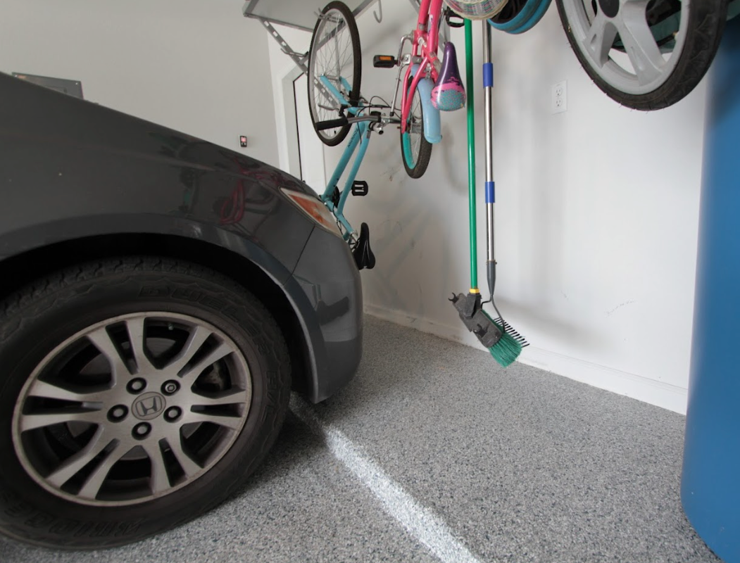 a car is parked in a garage next to a bike rack