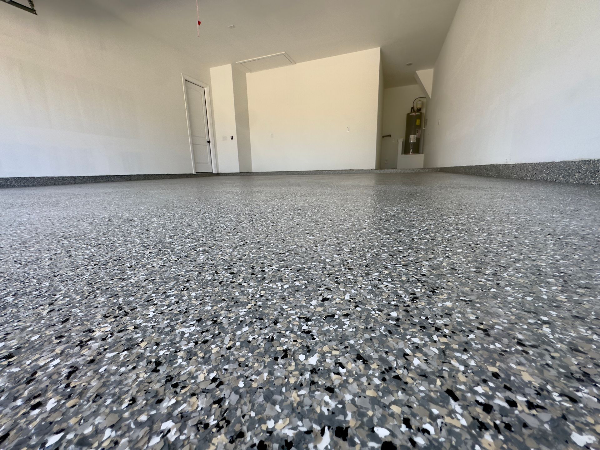 a garage with a concrete floor and white walls .