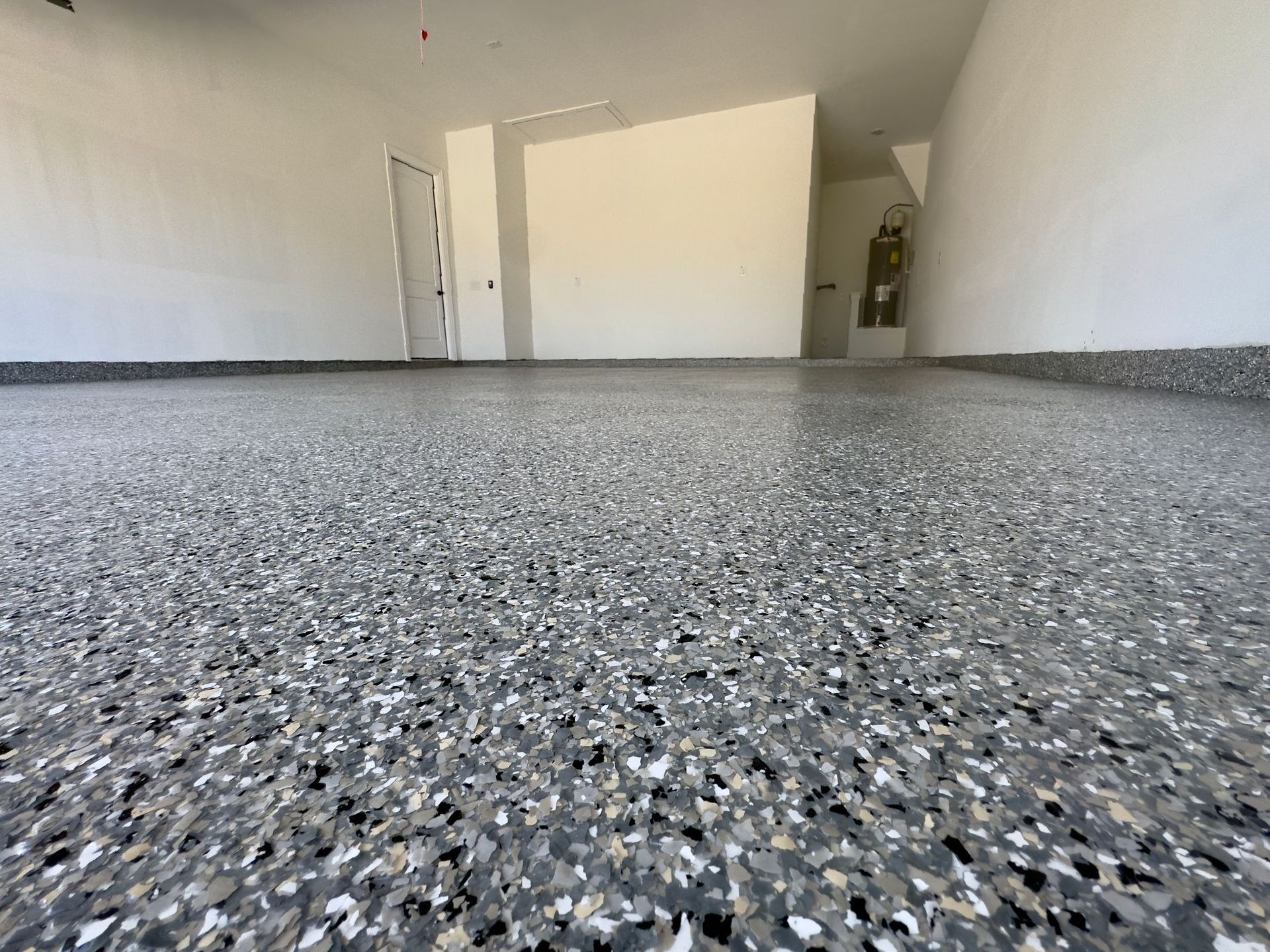 a garage with a gray concrete floor and white walls .