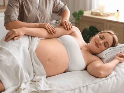 Person receiving a back massage with a handheld device on a spa table Person receiving a back massage with a handheld device on a spa table