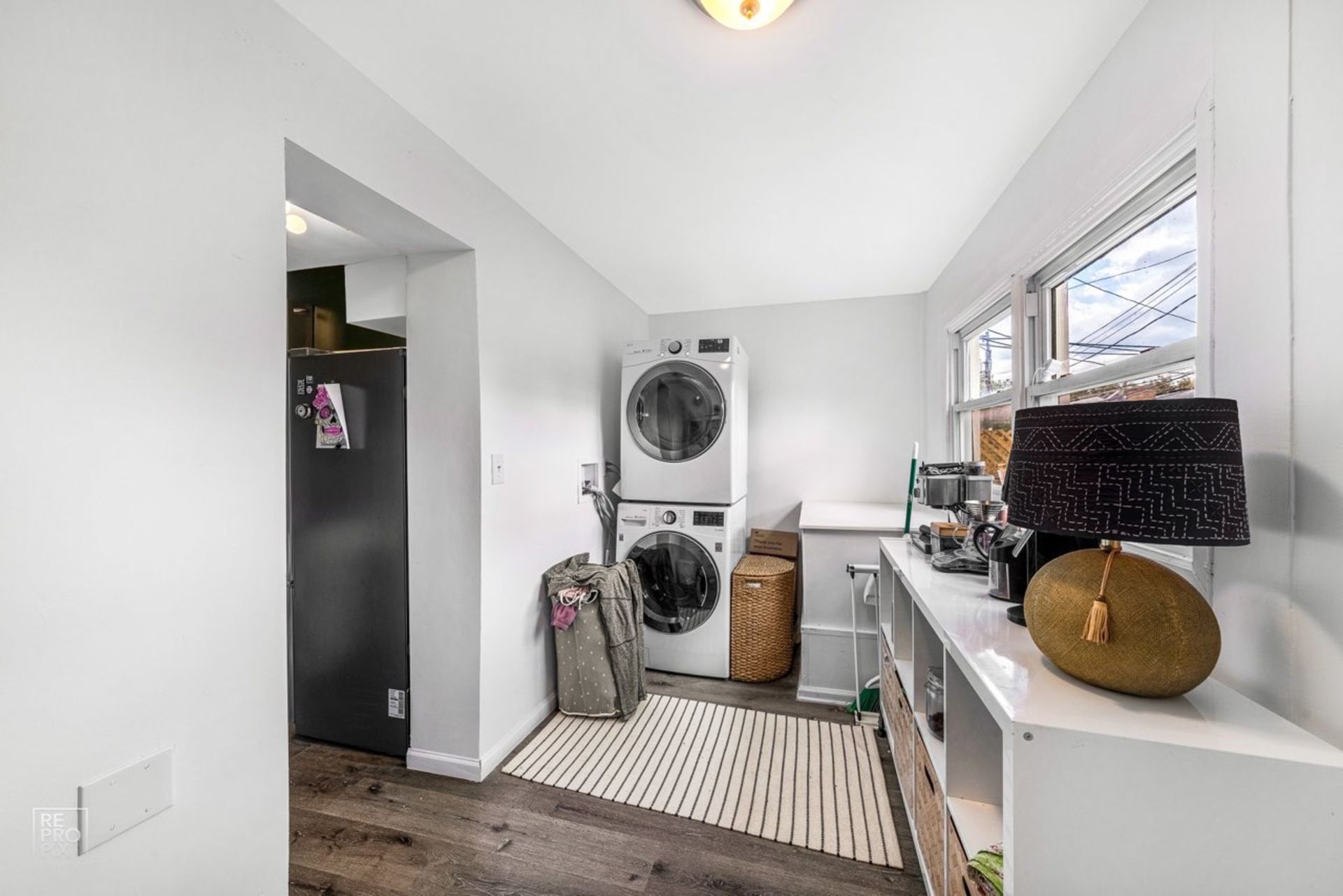 A laundry room with a washer and dryer stacked on top of each other.