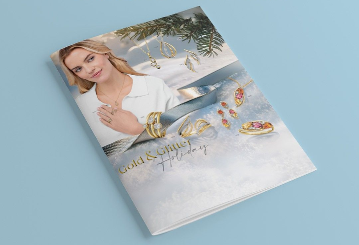 2025 Gold and Glitter Holiday Brochure on a light blue background