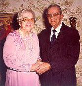 A man and a woman are shaking hands in a room.