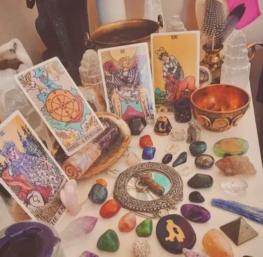 Tarot cards and two lit candles on a table