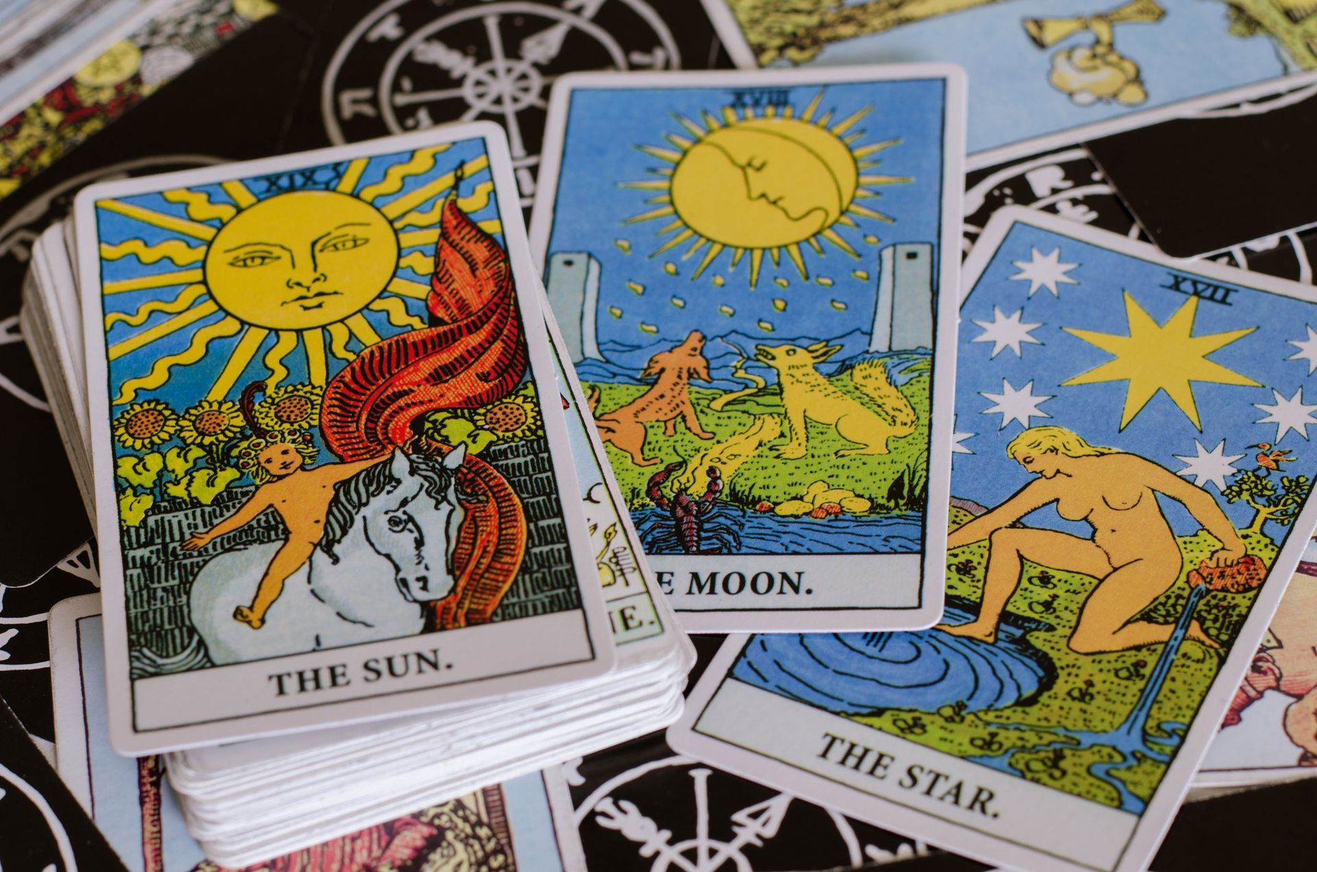 A stack of tarot cards including the sun moon and star