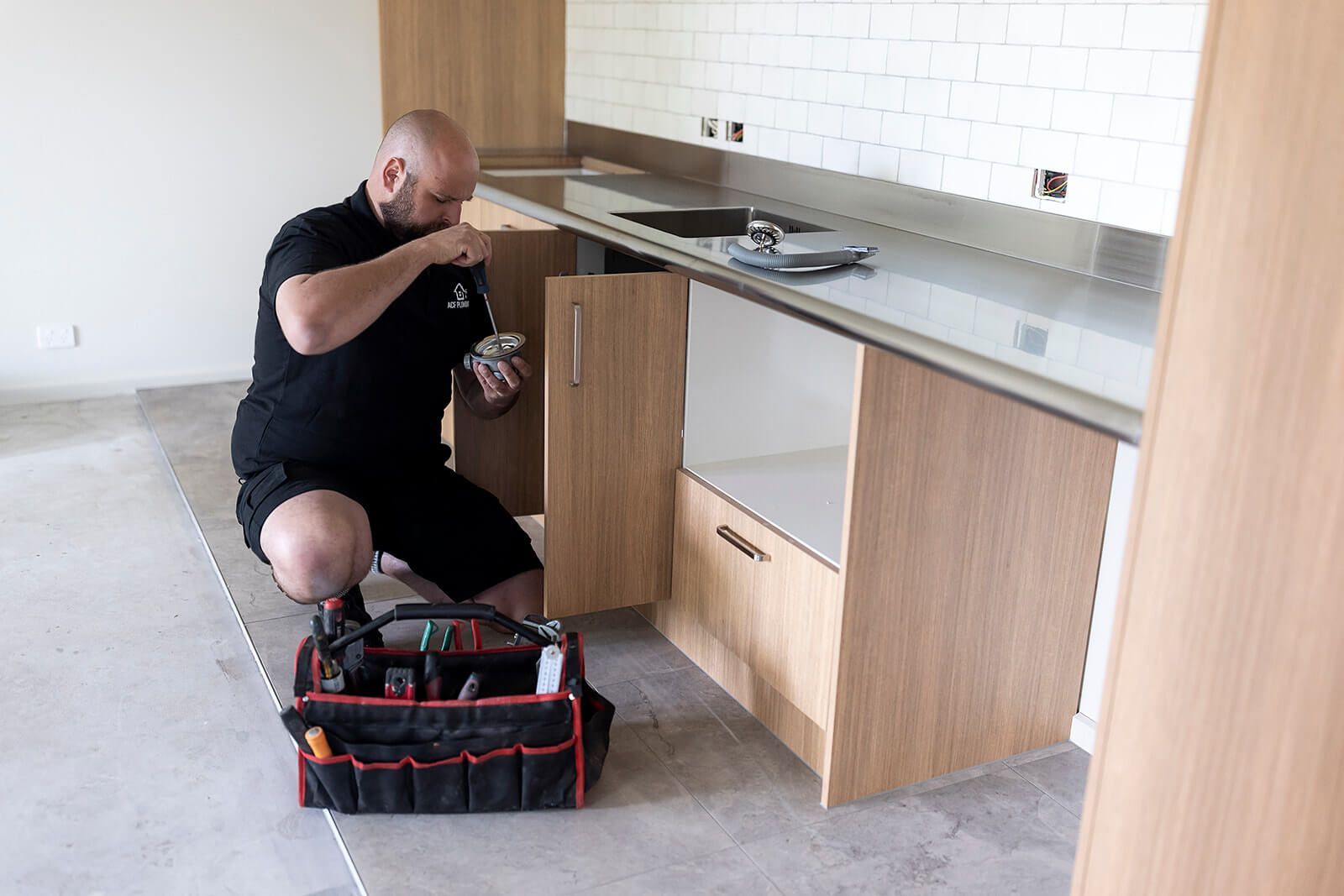 A bathroom with a sink and a drain pipe