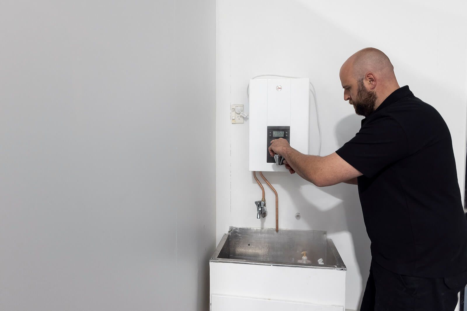 A stainless steel sink with a faucet in a kitchen.