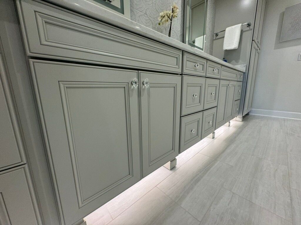 Gray bathroom vanity with under-cabinet lighting.