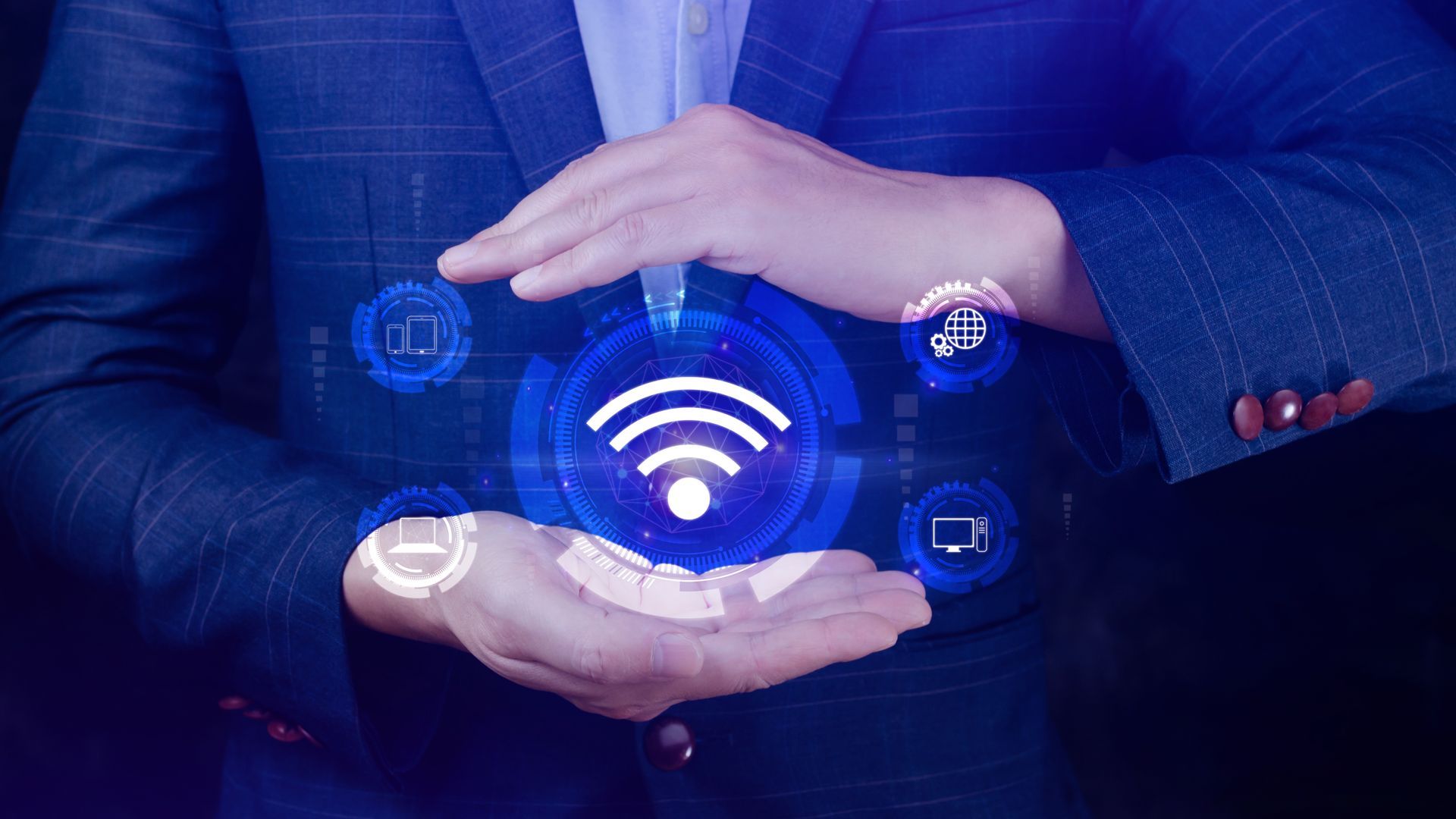 A man in a suit is holding a wifi symbol in his hands.