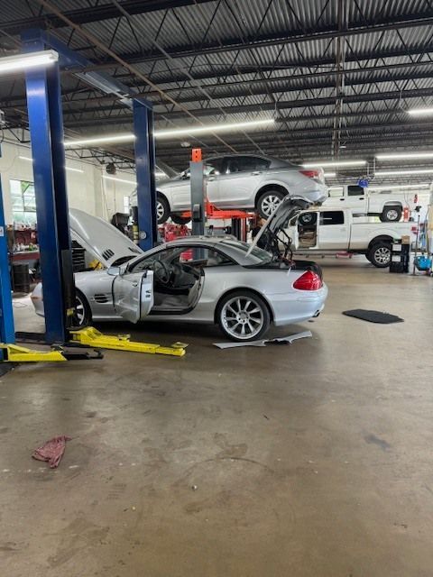 Silver sports car with open doors and trunk | Superior Auto Service