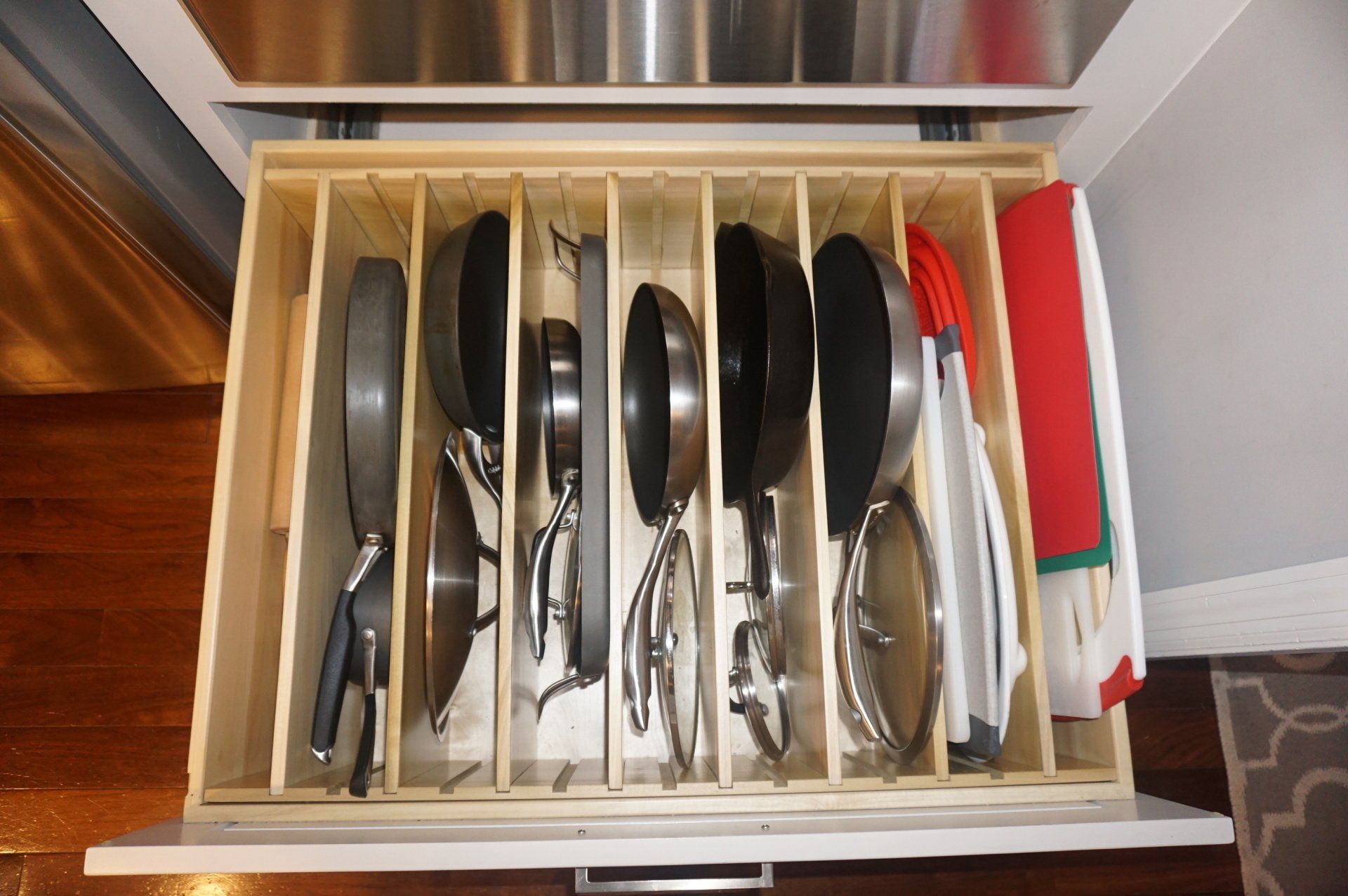 Wood cookware organizer for base cabinet.