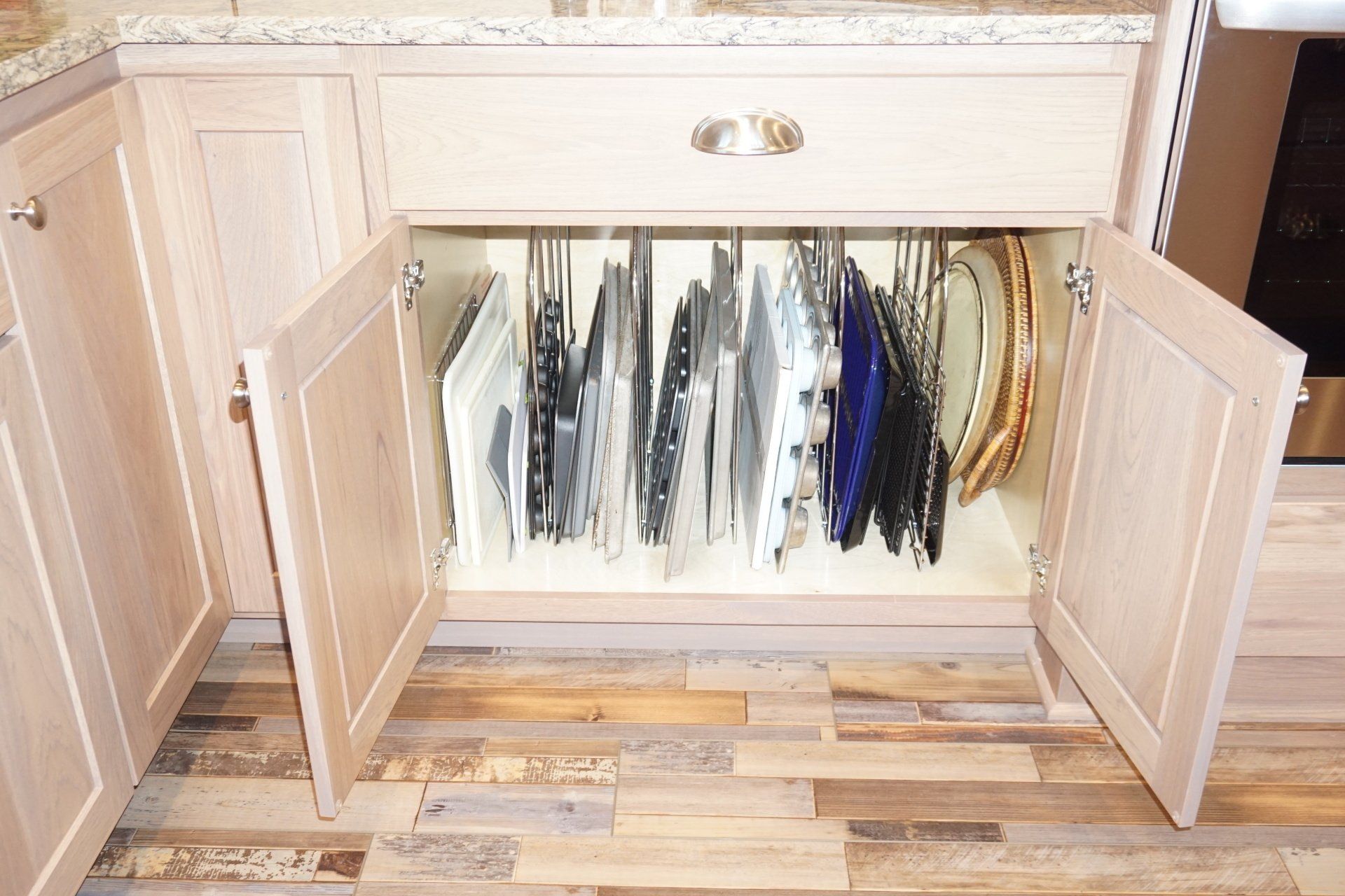 Kitchen base cabinet baking sheet organizer.