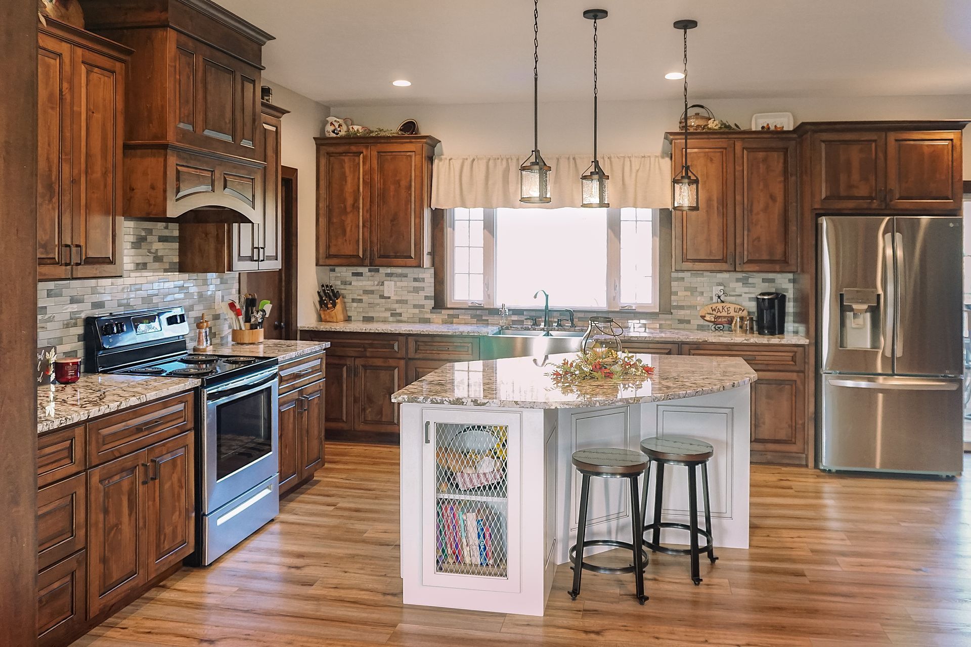 Custom stained traditional wood kitchen cabinets with quartz countertops.