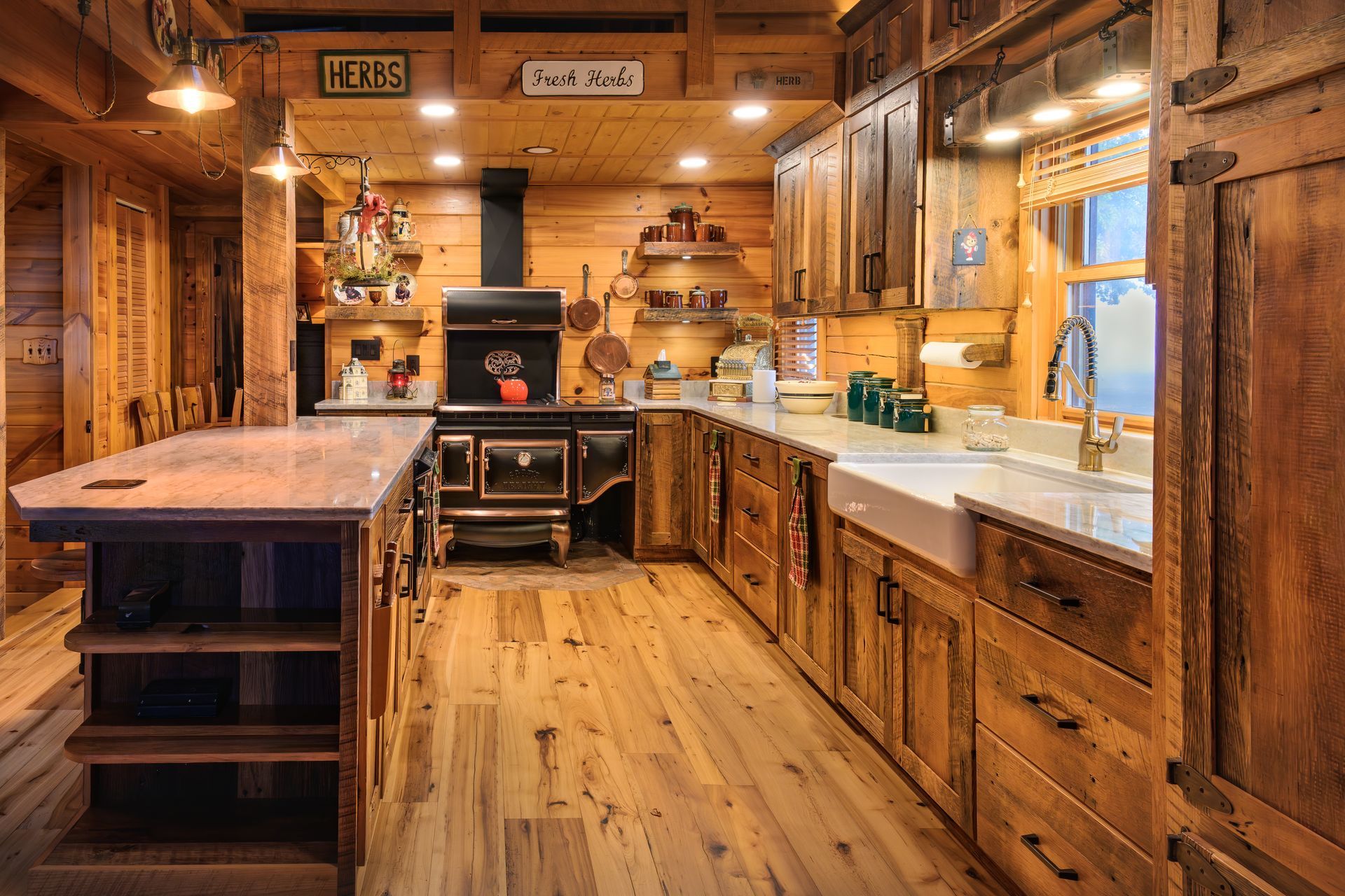 Custom kitchen cabinets & island, rustic rough sawn look and farmhouse sink with quartz countertops.