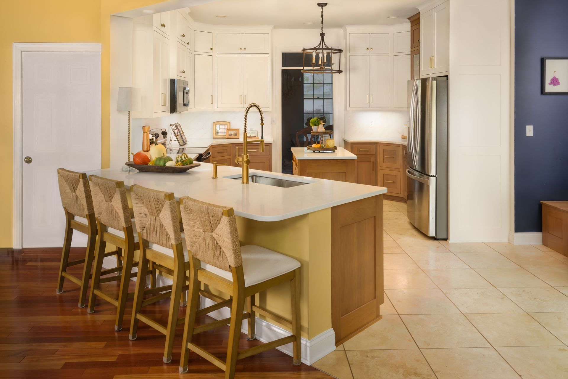 Custom painted and stained kitchen cabinets and island with modern inset doors and quartz countertops.
