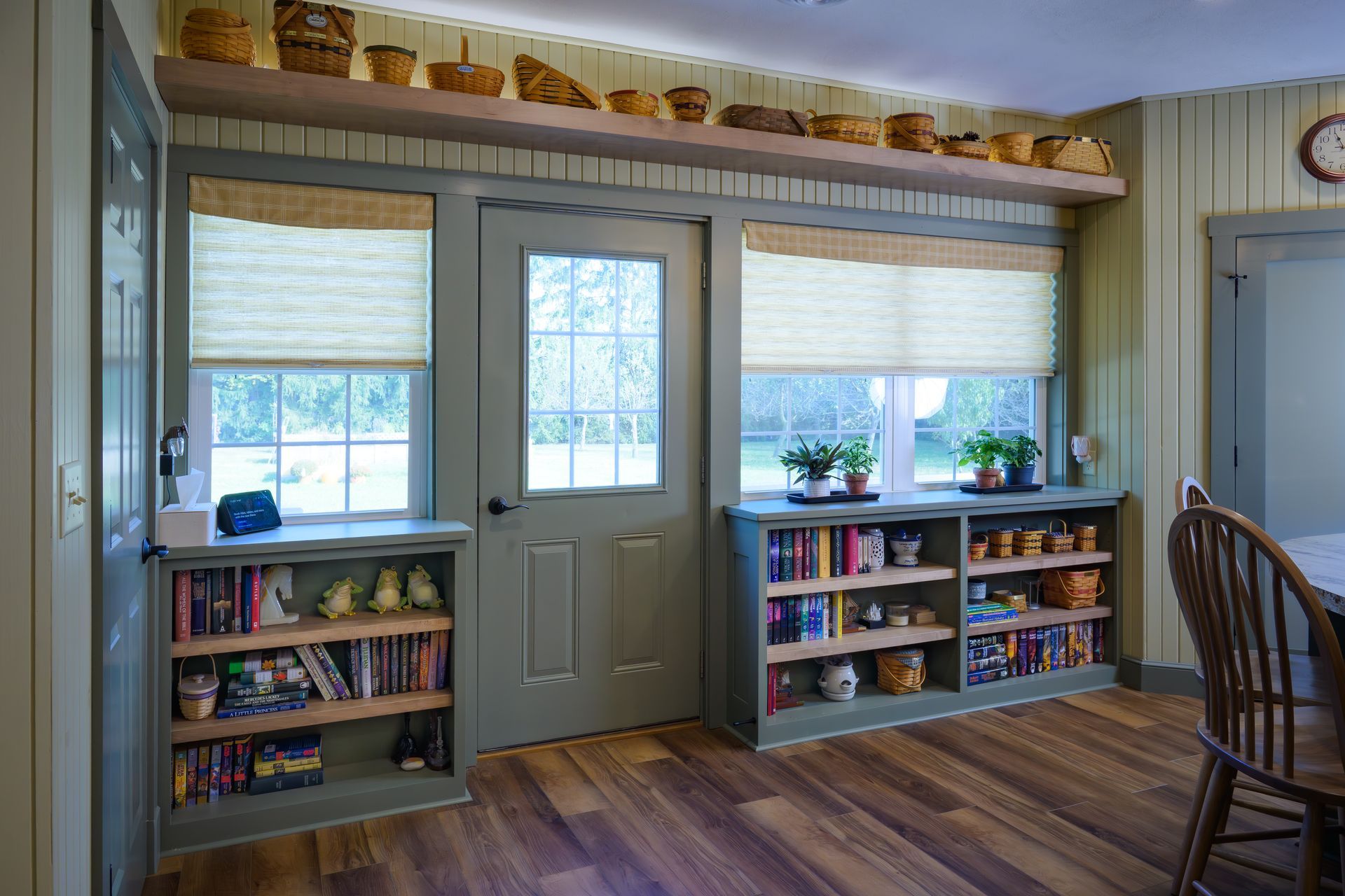 Custom green painted wood built-in bookshelves and floating shelf for dining room.
