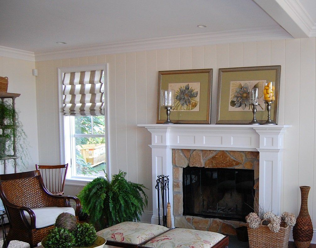Custom white painted wood fireplace mantel and surround with arched opening.