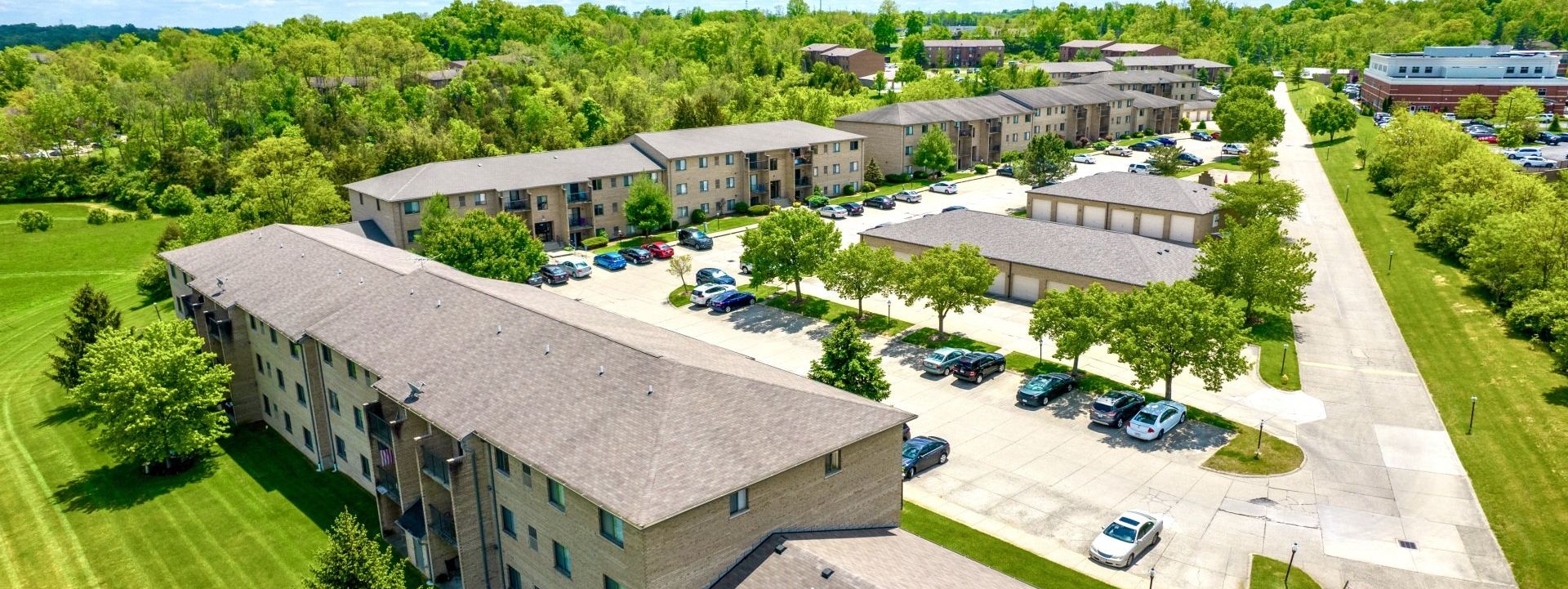 An aerial view of a residential area with lots of buildings and trees.