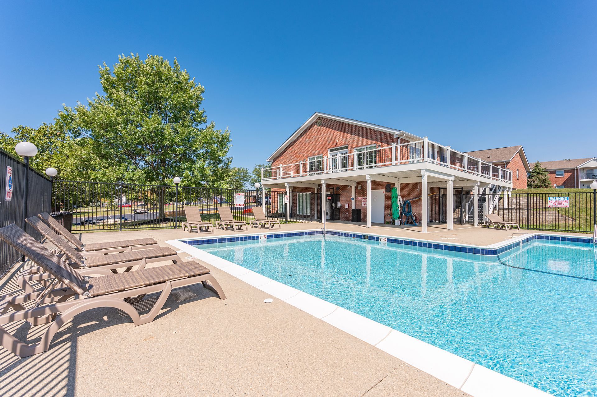 There is a large swimming pool in front of a building.