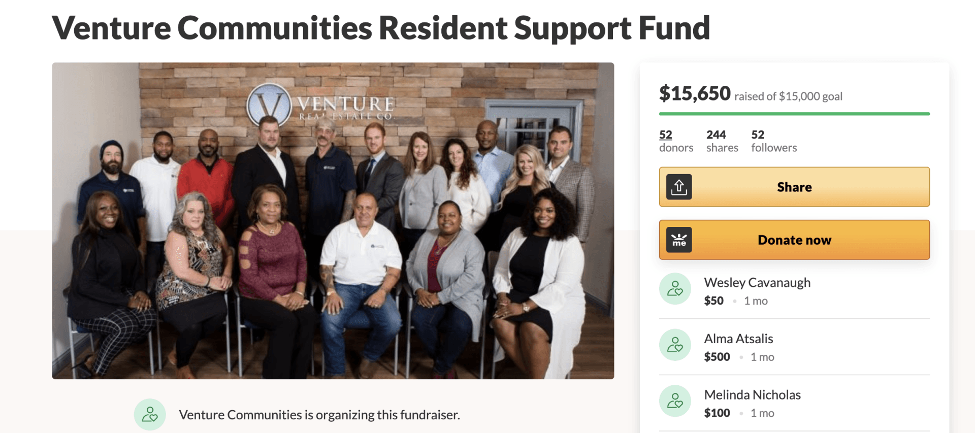 A group of people are sitting in chairs in front of a brick wall.