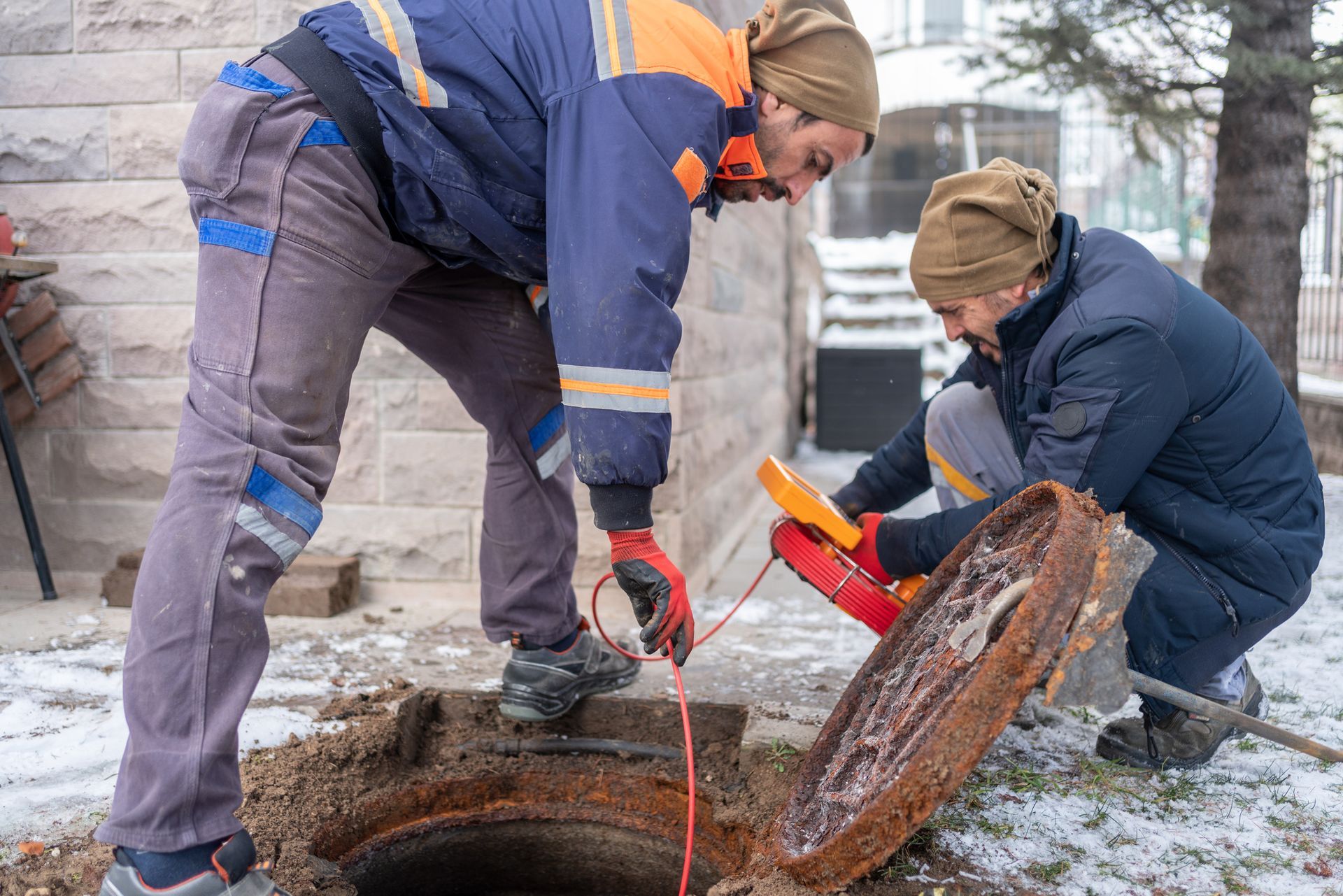 Two men are inspecting a septic system.