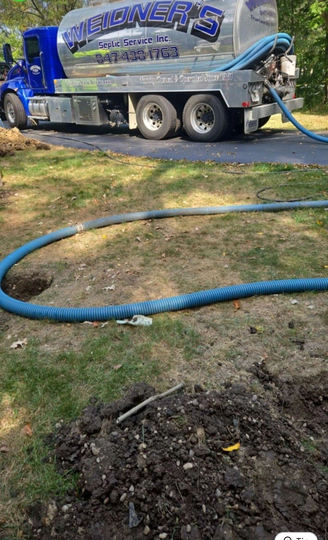 Septic tank being pumped in the garden by Weidner's Septic Service | Crystal Lake, IL