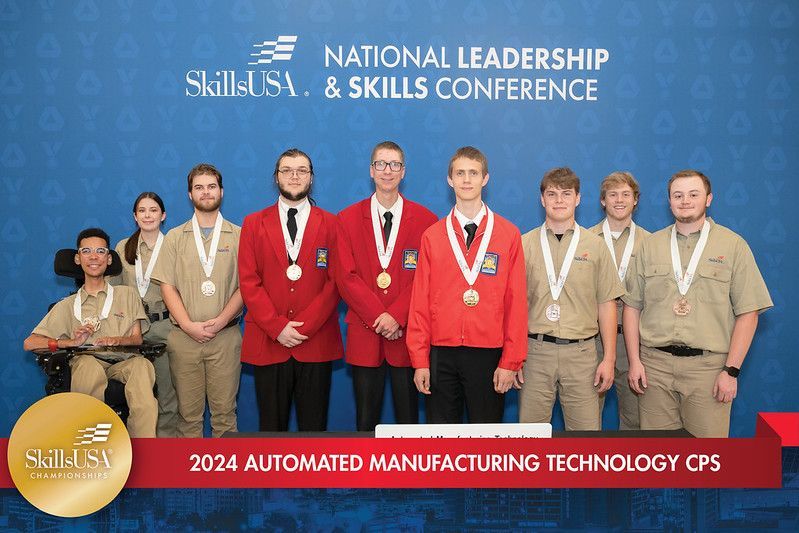 A group of people are posing for a picture at the national leadership and skills conference