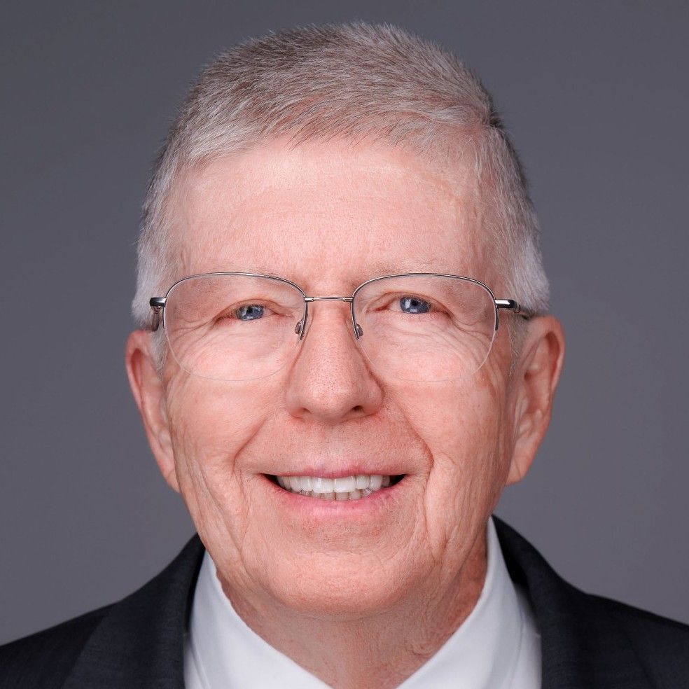 A man and a woman are standing next to each other holding trophies.