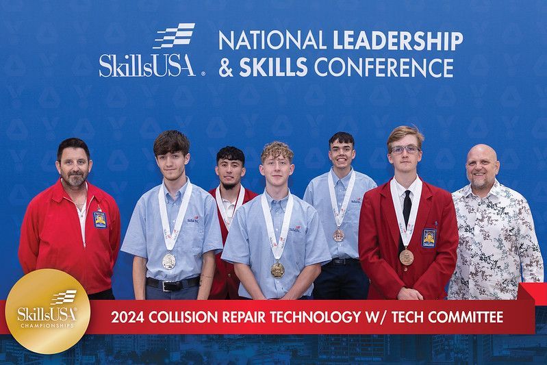 A group of young men are posing for a picture at the national leadership and skills conference.