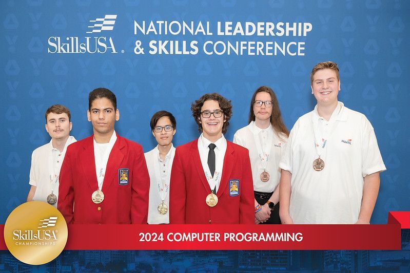 A group of young people are posing for a picture at the national leadership and skills conference.