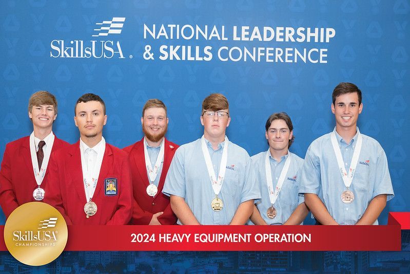 A group of young men are standing next to each other wearing medals.