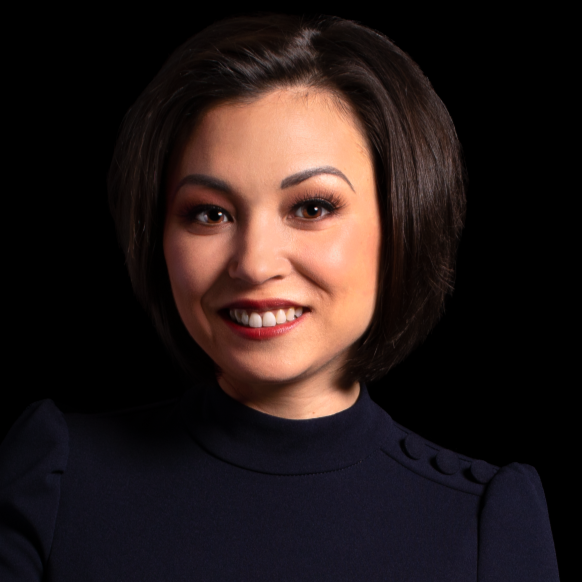 A man in a suit and tie is smiling for the camera.