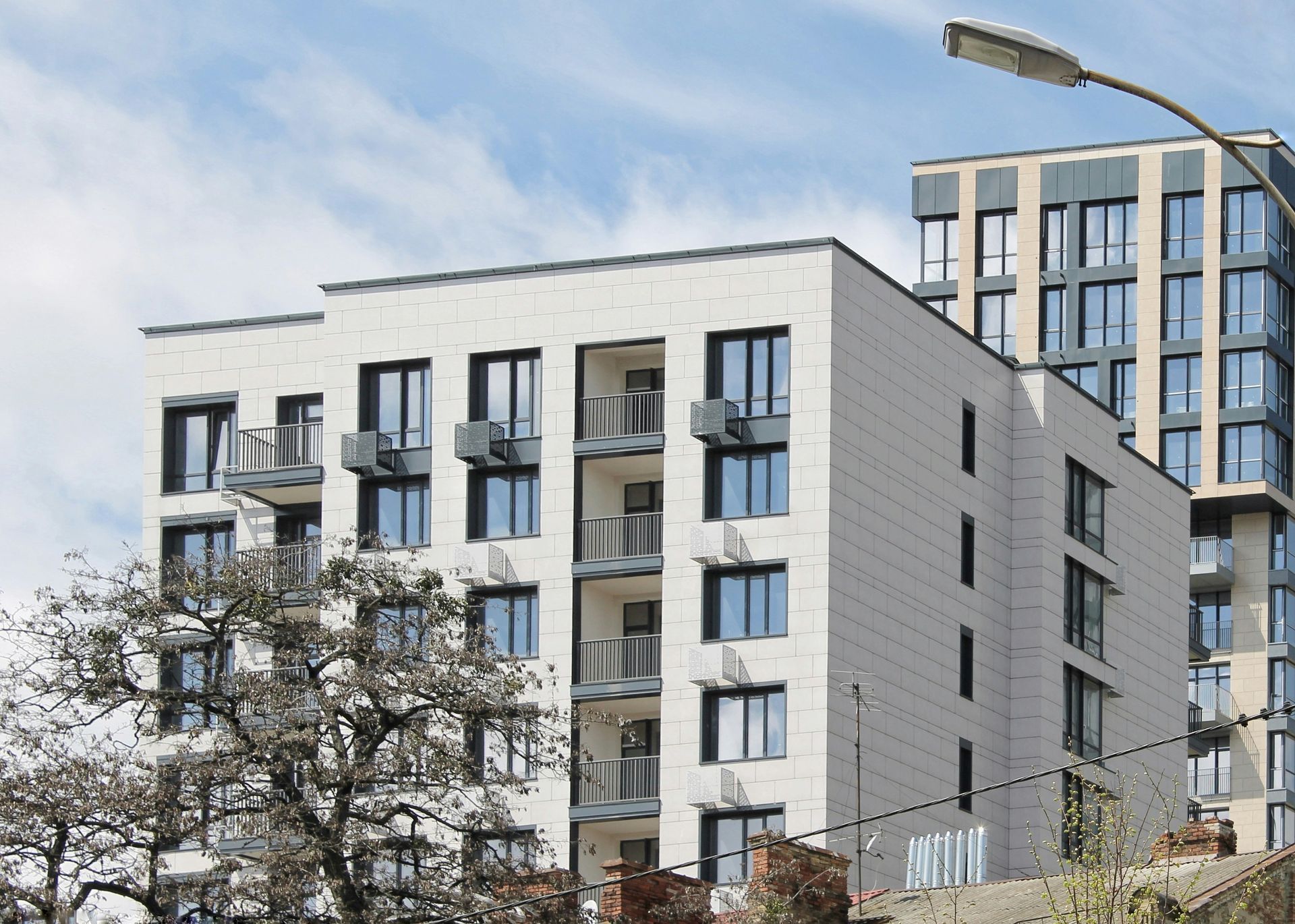 A woman is walking down the street holding a cup of coffee.