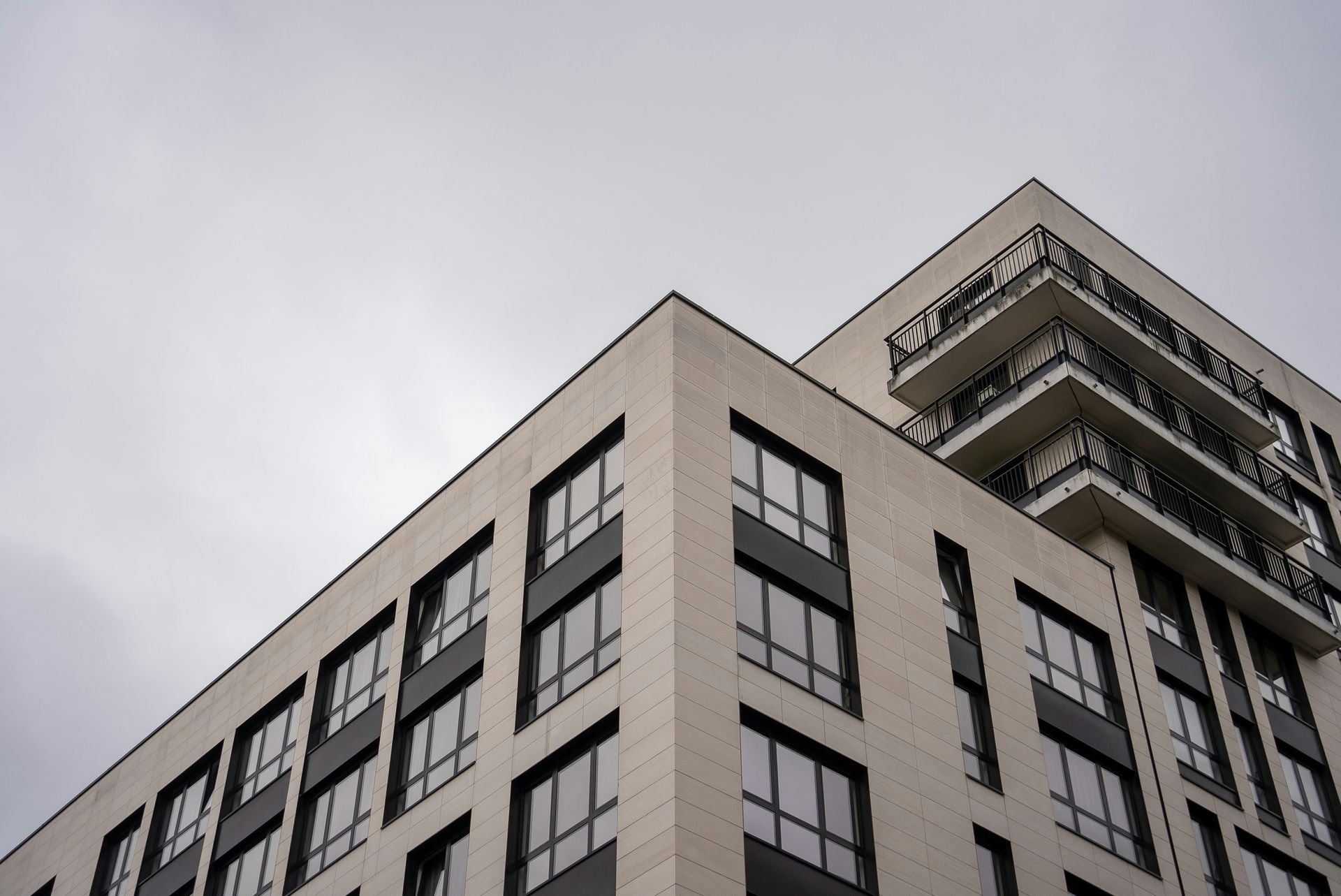 A woman is walking down the street holding a cup of coffee.