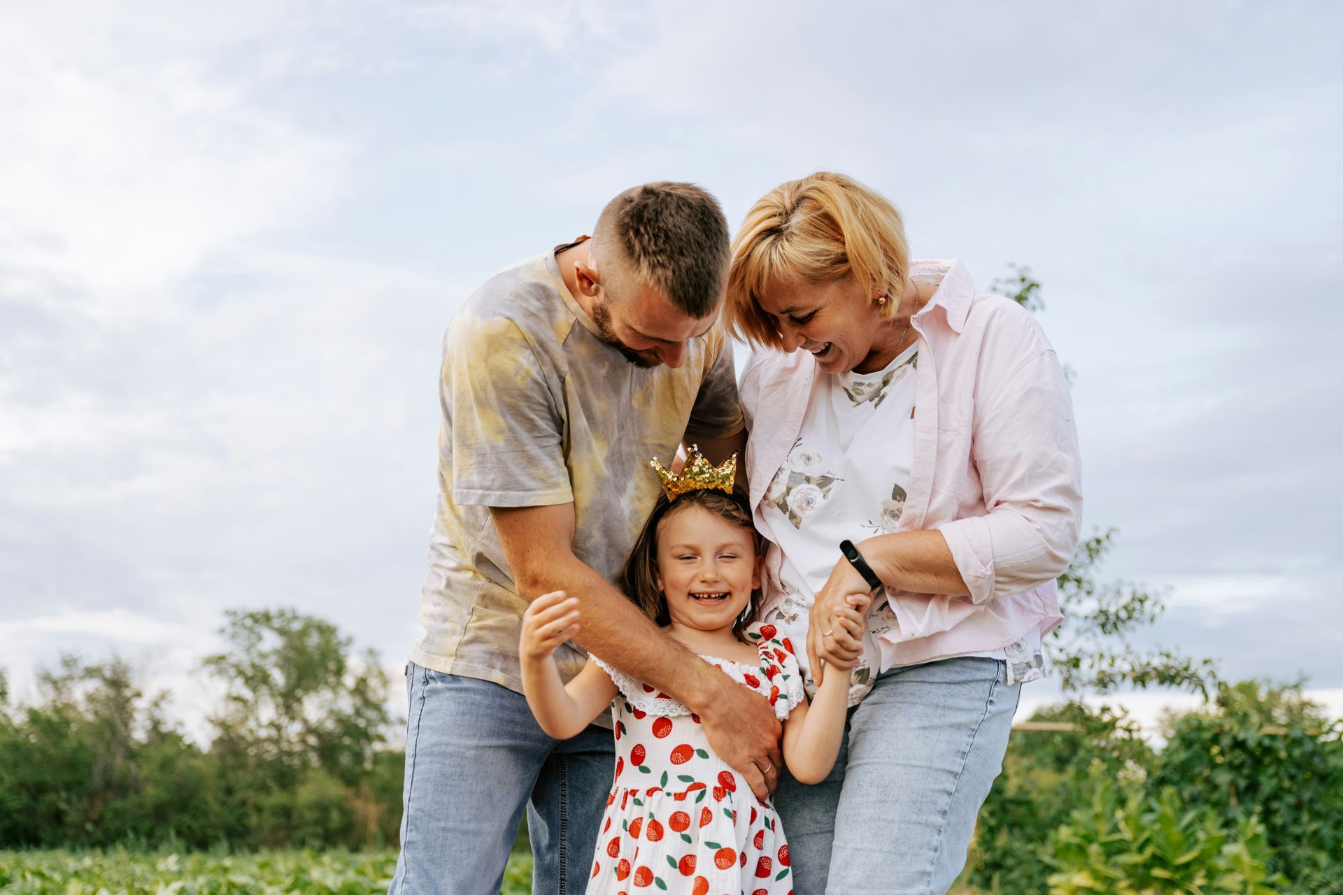 A woman is walking down the street holding a cup of coffee.