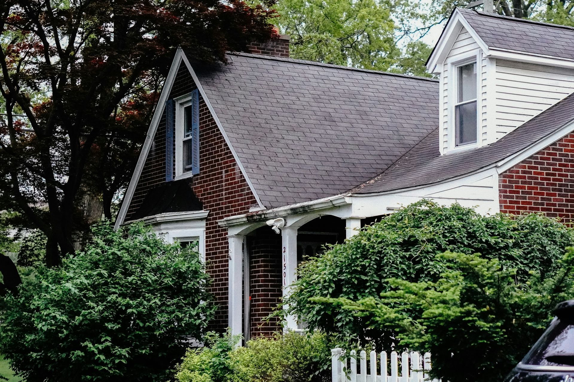 A woman is walking down the street holding a cup of coffee.