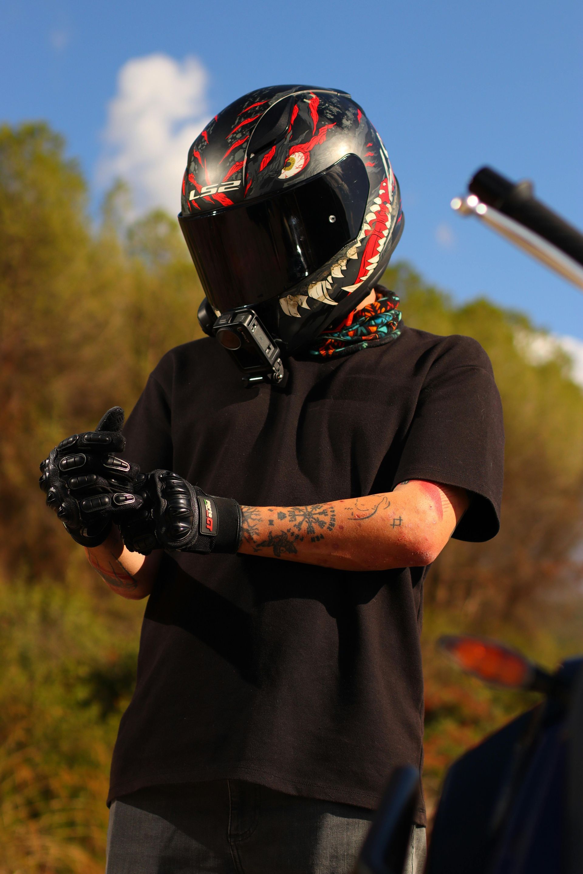A woman is sitting at a table looking at her cell phone.