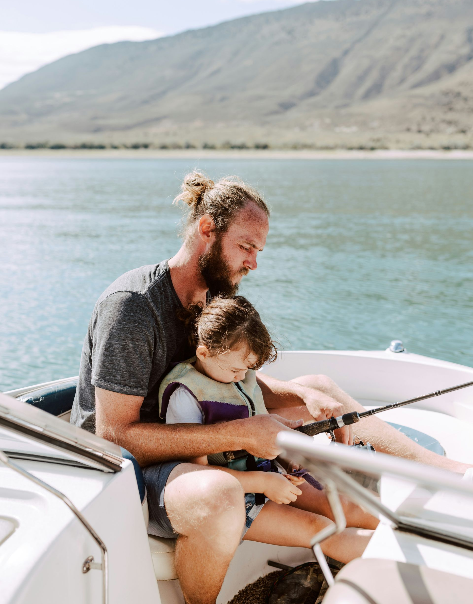 A woman is sitting at a table looking at her cell phone.